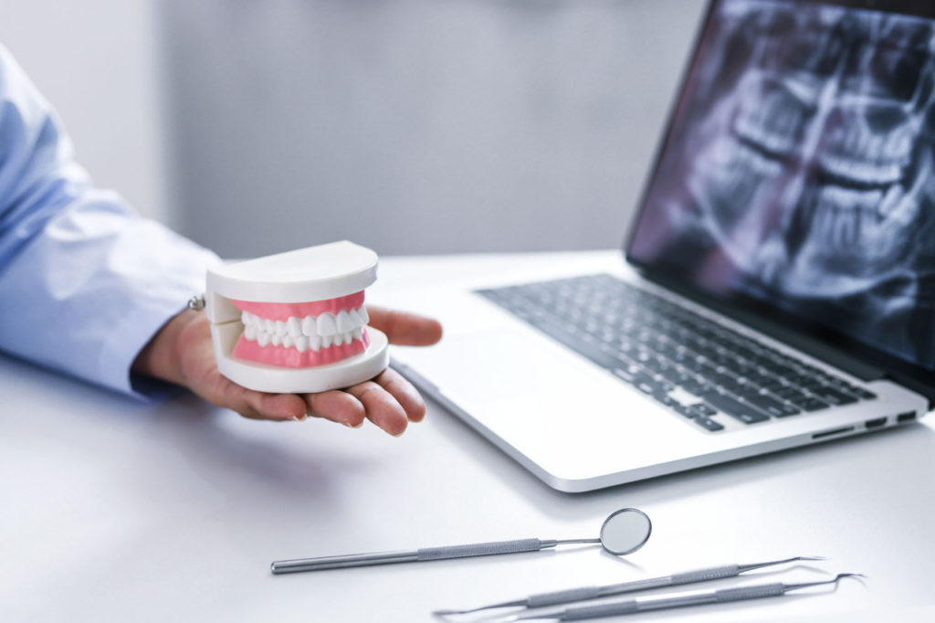 Dentist examining a patient teeth medical treatment at the denta